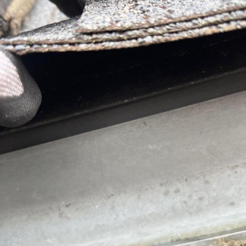 Roof flashing detail with visible wear and damage