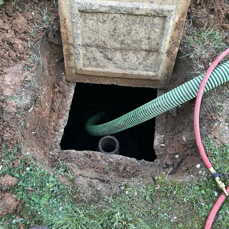 Septic tank pumping with hose in Chattanooga yard