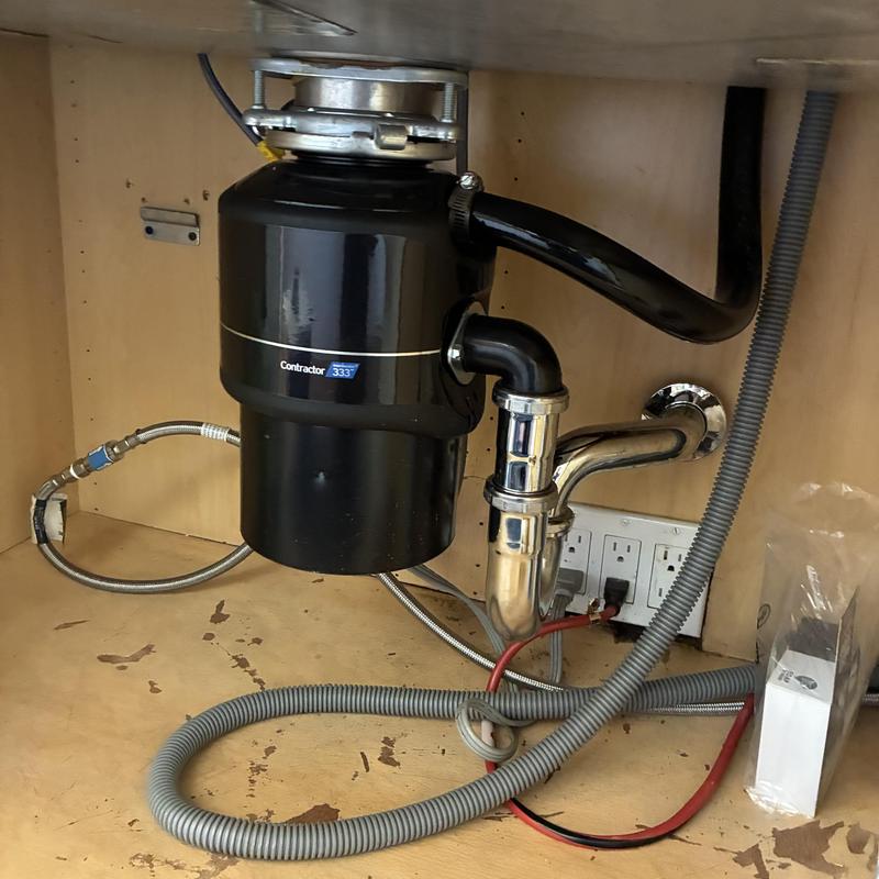 Garbage disposal unit installation under kitchen sink
