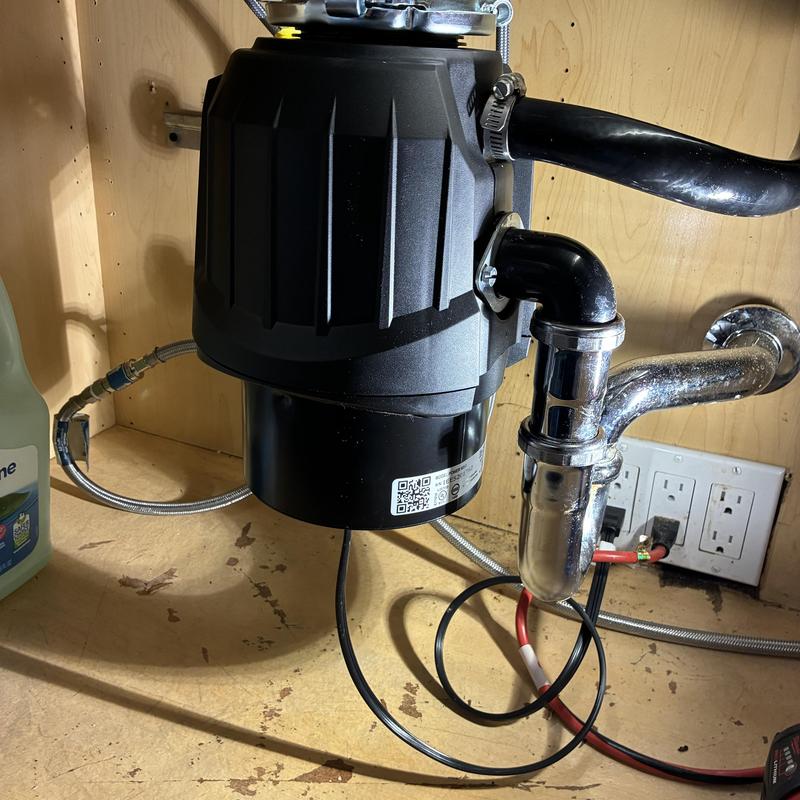 Garbage disposal unit installed under kitchen sink