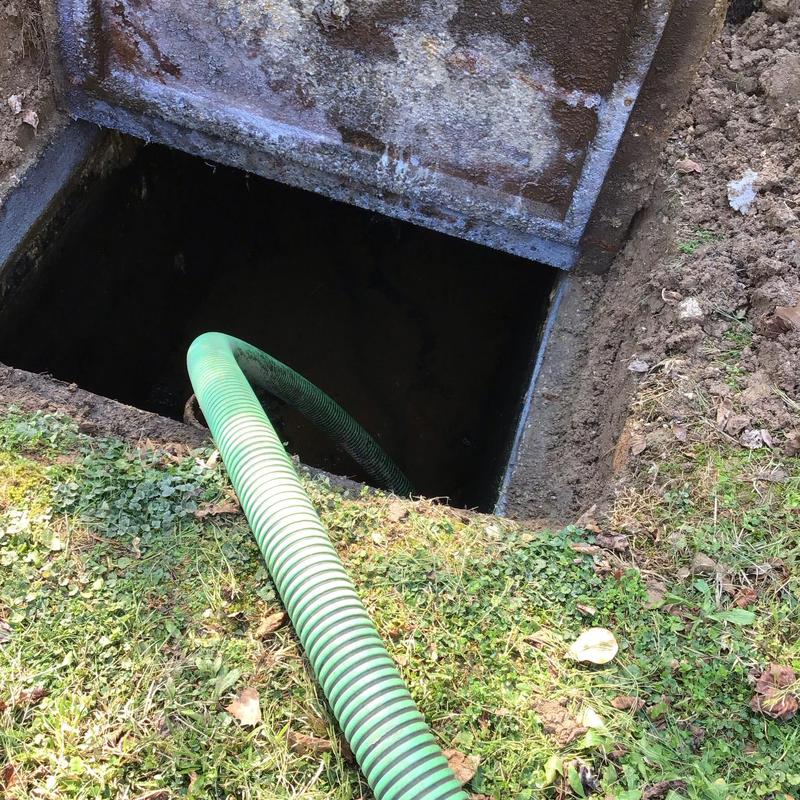 Septic tank pumping with green suction hose