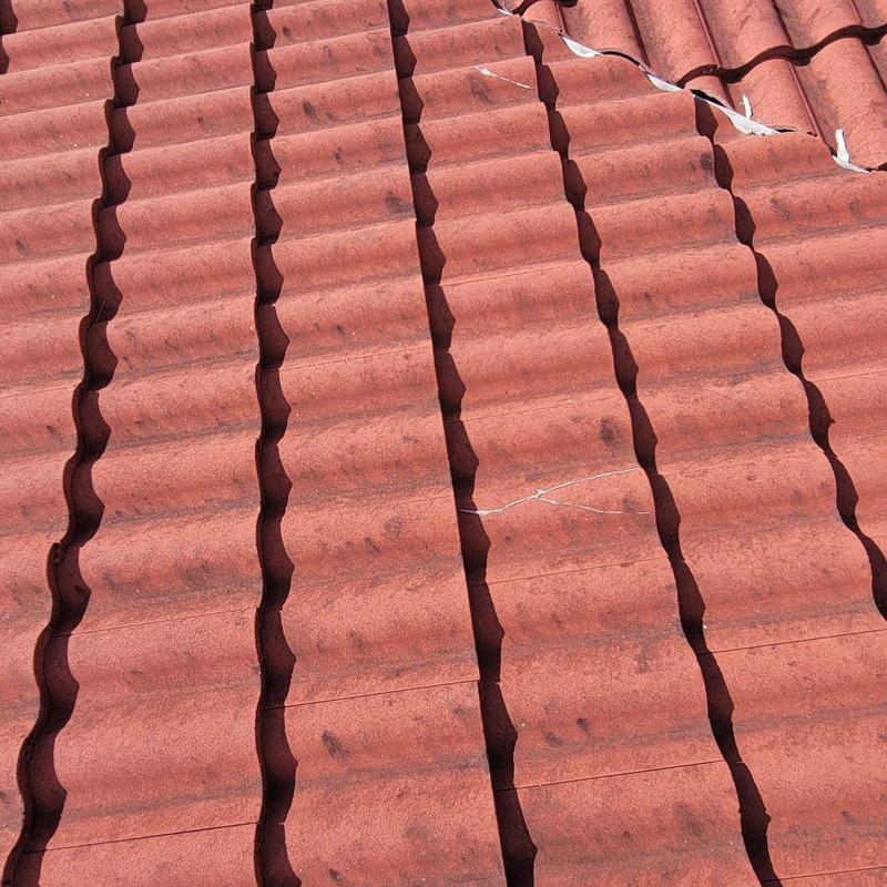 Concrete tile roof with cracked and repaired tiles
