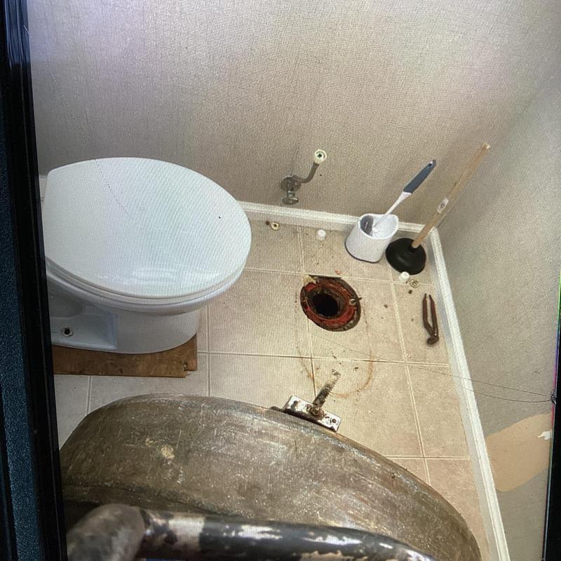 Toilet flange and surrounding floor before installation