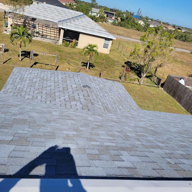 Shingle roof with secured hip cap and field shingles