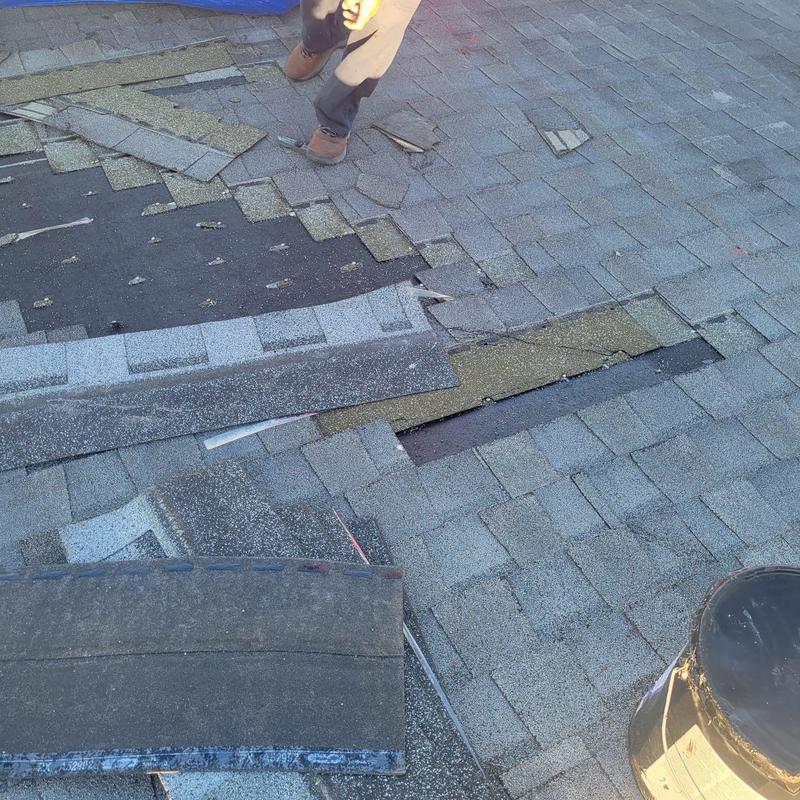 Shingle roof with missing and damaged sections