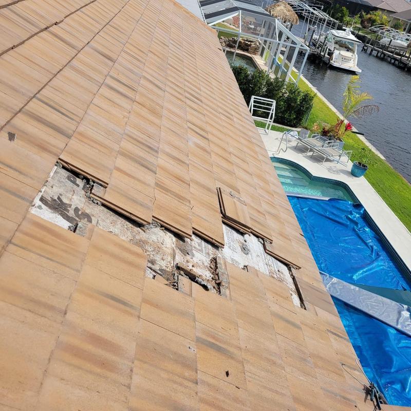 Concrete roof tiles with missing sections near pool