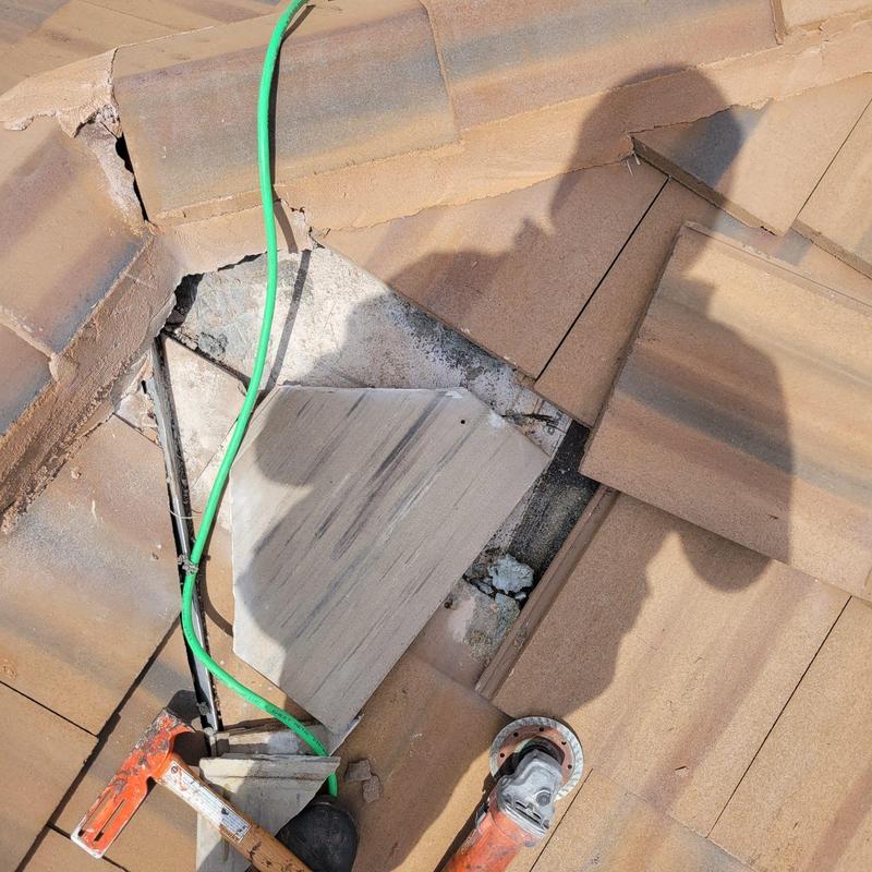 Concrete tile roof with broken tile removal and repair