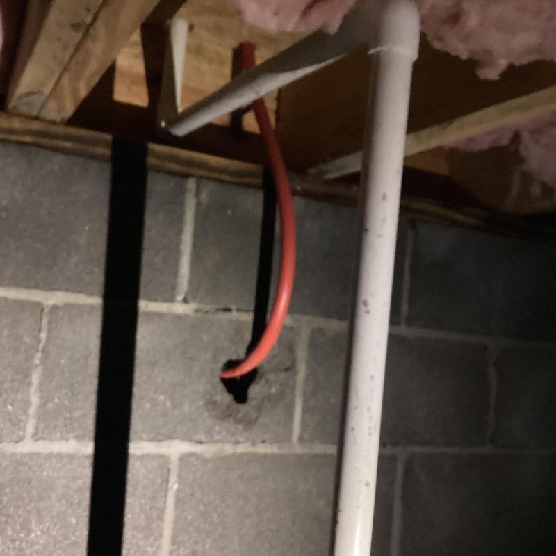 PVC drain pipe installation under house with insulation above