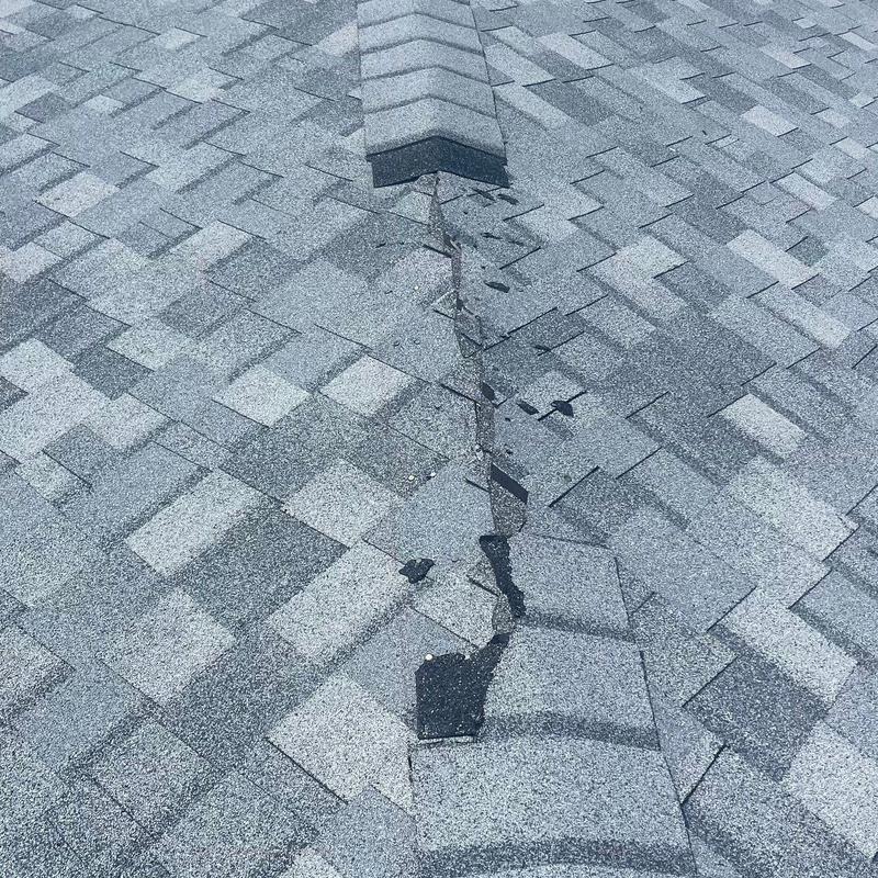 Hip cap shingles on shingle roof with repair sealant application