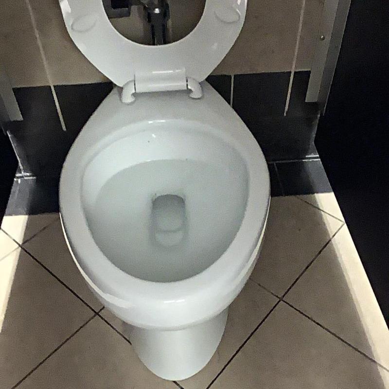 Toilet bowl with water level indicating clog in line