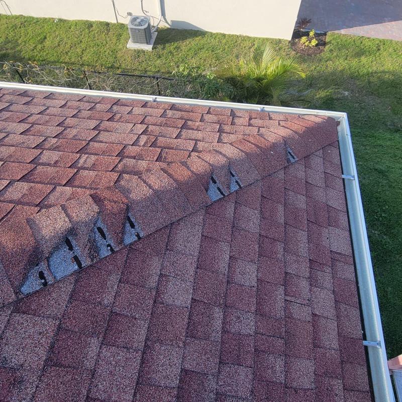Shingle roof with missing cap shingles and damage