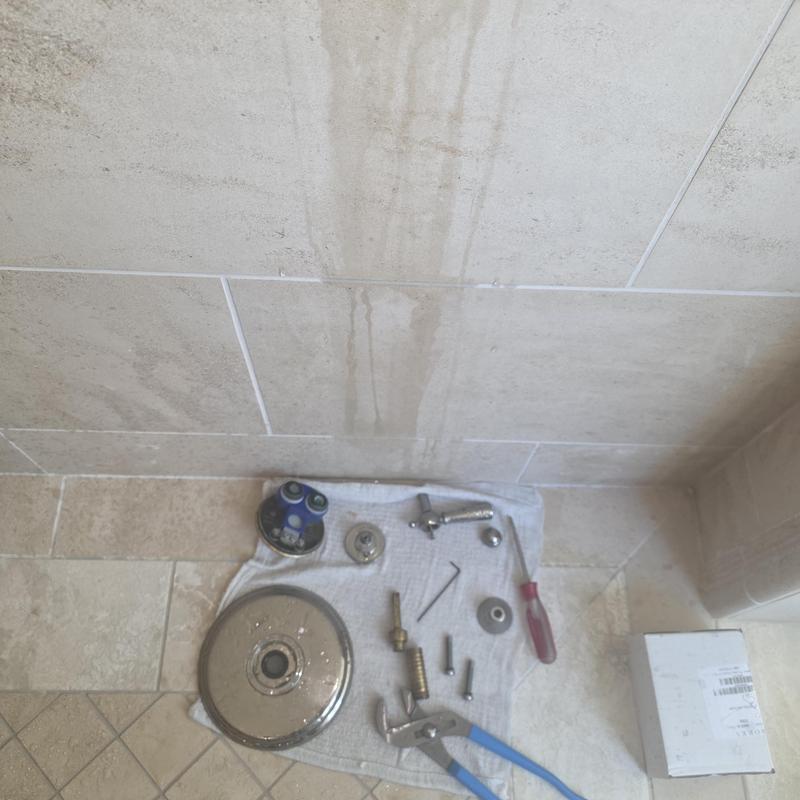 Thermostatic shower valve cartridges with tools laid out Thermostatic shower valve cartridges with tools laid out