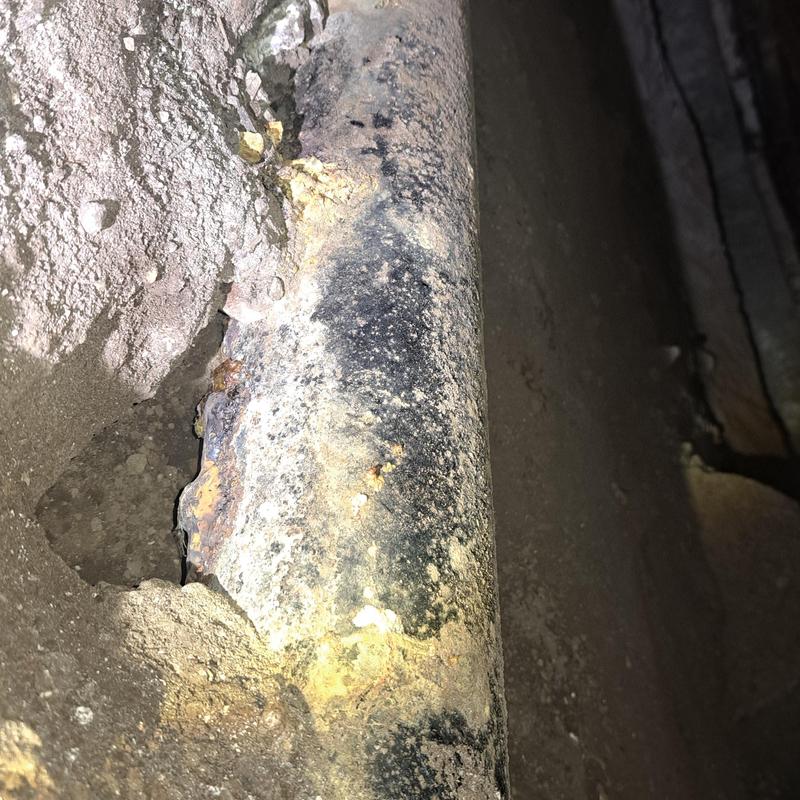 Cast iron drain pipe with corrosion under house