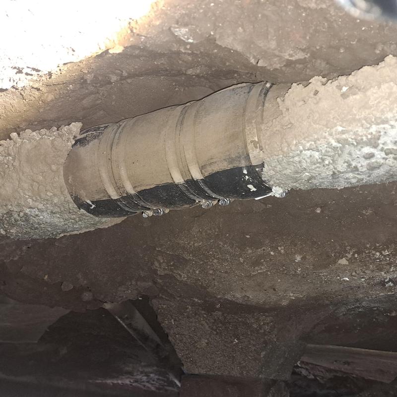 Cast iron drain pipe with repair couplings under house