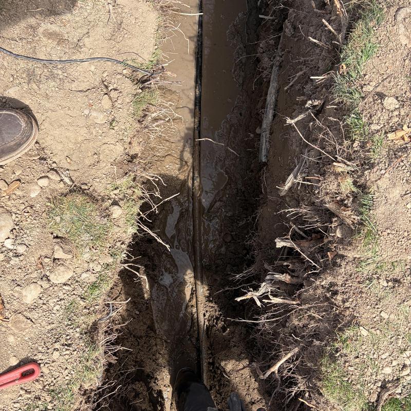 1-inch watermain pipe trench with mud and roots 1-inch watermain pipe trench with mud and roots