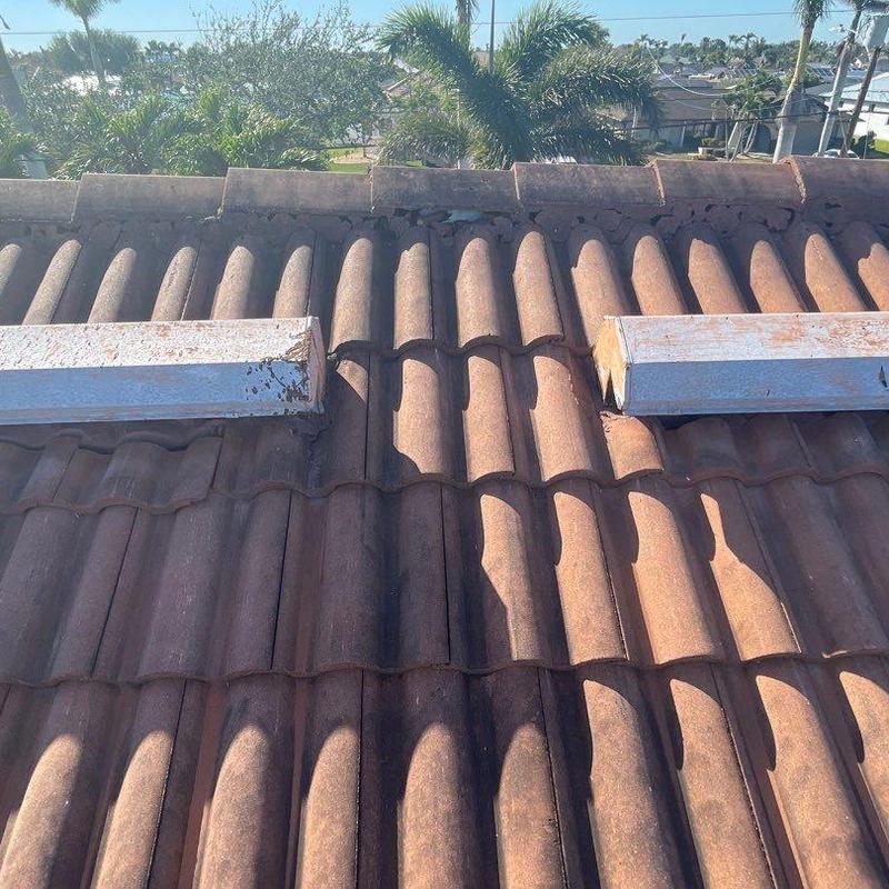 Concrete tile roof with mortar failure and metal vents