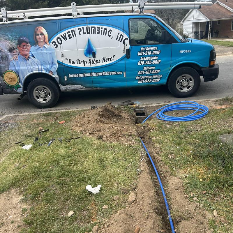 Water service line replacement with blue piping and van Water service line replacement with blue piping and van