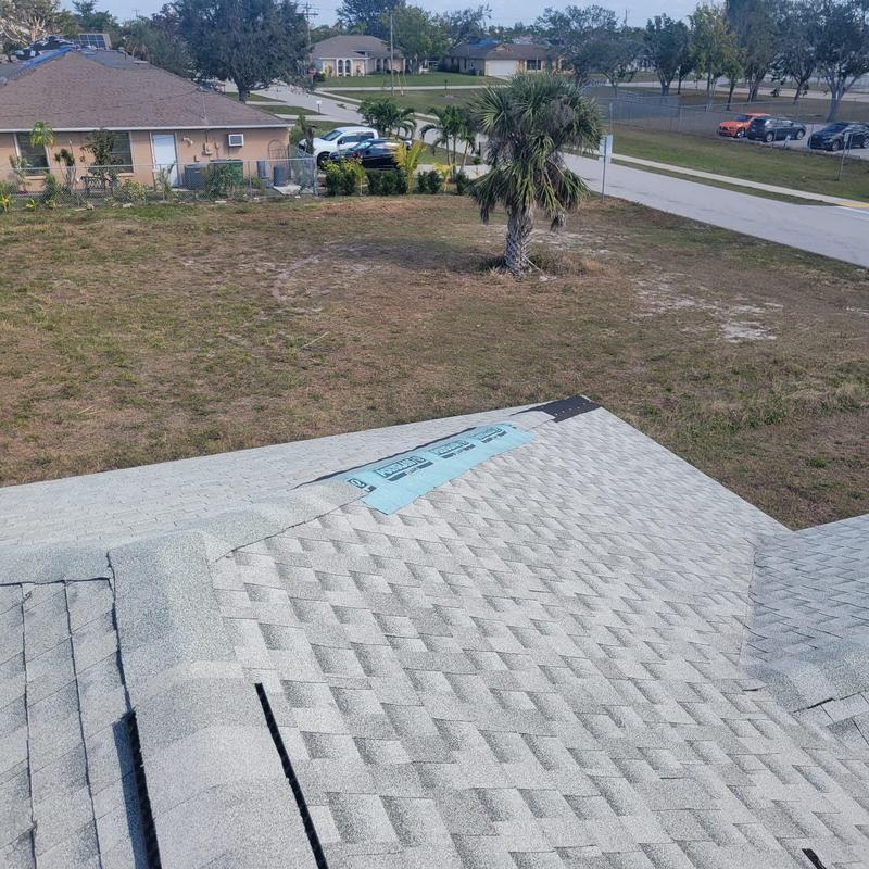 Shingle roof section with repaired damaged area in Cape Coral