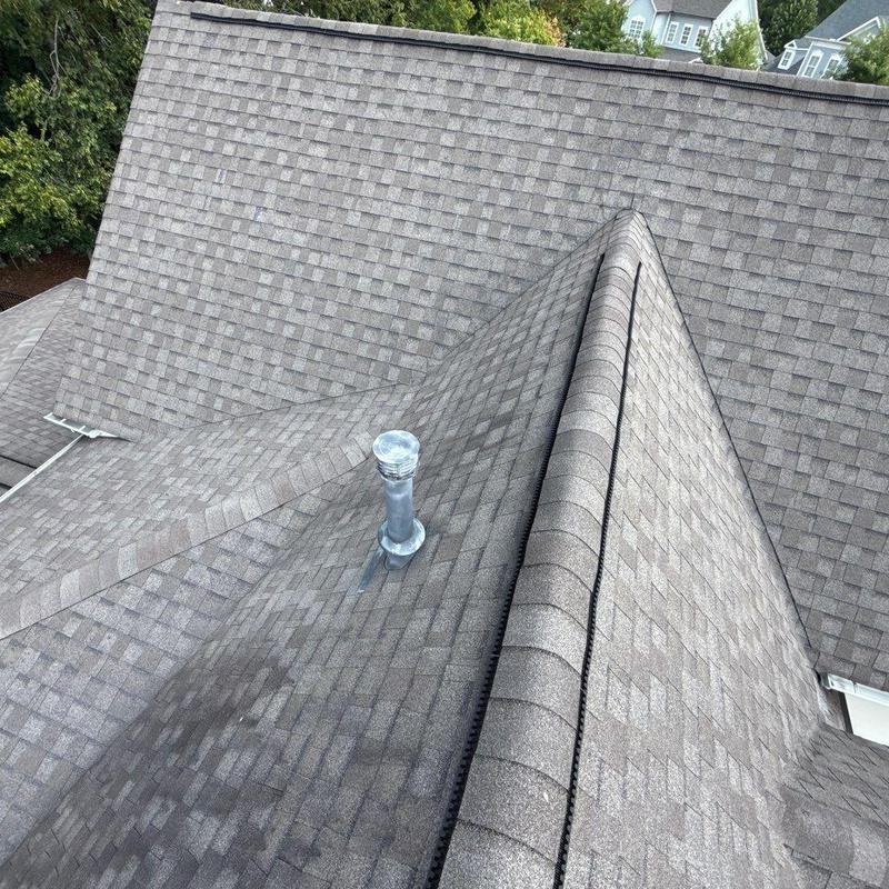 Asphalt shingle roof with vent pipe on residential home