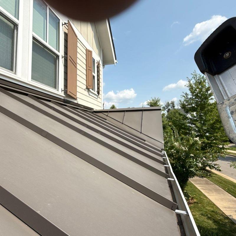 Standing seam metal roof inspection near windows