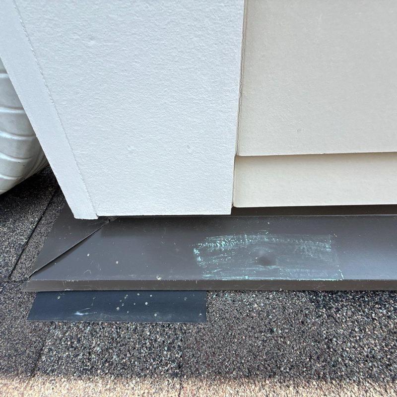 Metal roof flashing with paint damage and dent