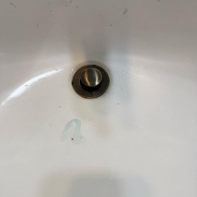 Bathroom sink pop-up drain assembly in white basin Bathroom sink pop-up drain assembly in white basin