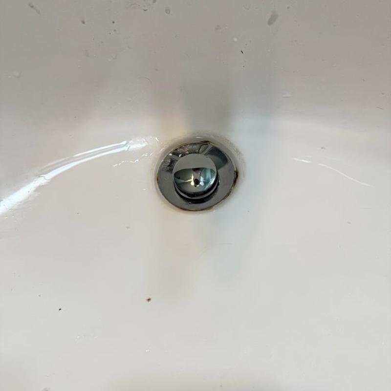 Pop-up drain assembly in bathroom sink detail Pop-up drain assembly in bathroom sink detail