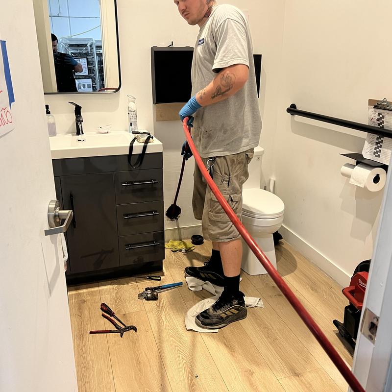 Main sewer line cleaning with hydro jet in restroom