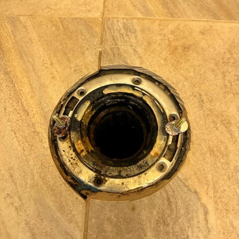 Toilet flange and wax ring with exposed floor drain Toilet flange and wax ring with exposed floor drain