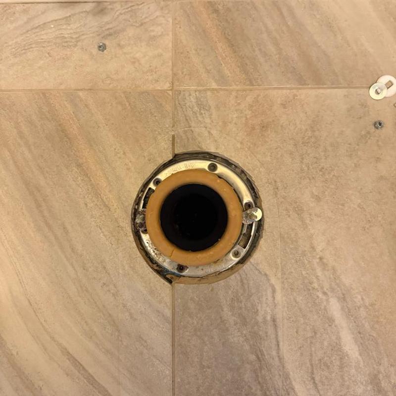 Toilet flange and wax ring on tiled floor Toilet flange and wax ring on tiled floor