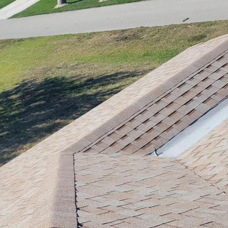 Shingle roof valley with repaired flashing detail