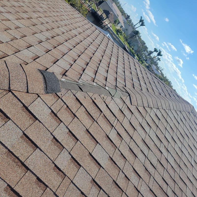 Shingle roof with partial damaged ridge cap in Cape Coral