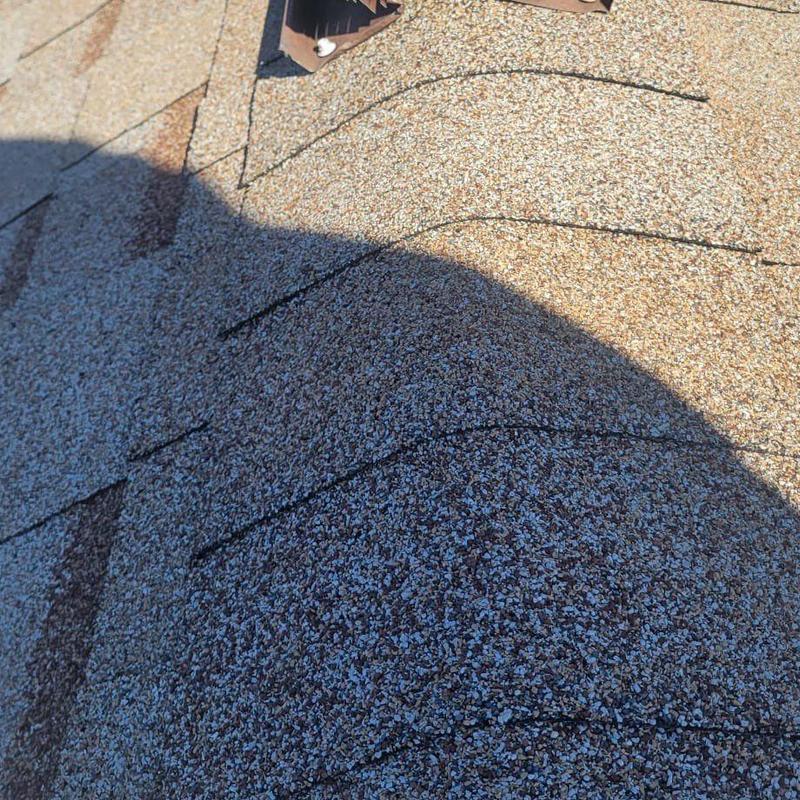 Shingle roof with repair marks and granules close-up