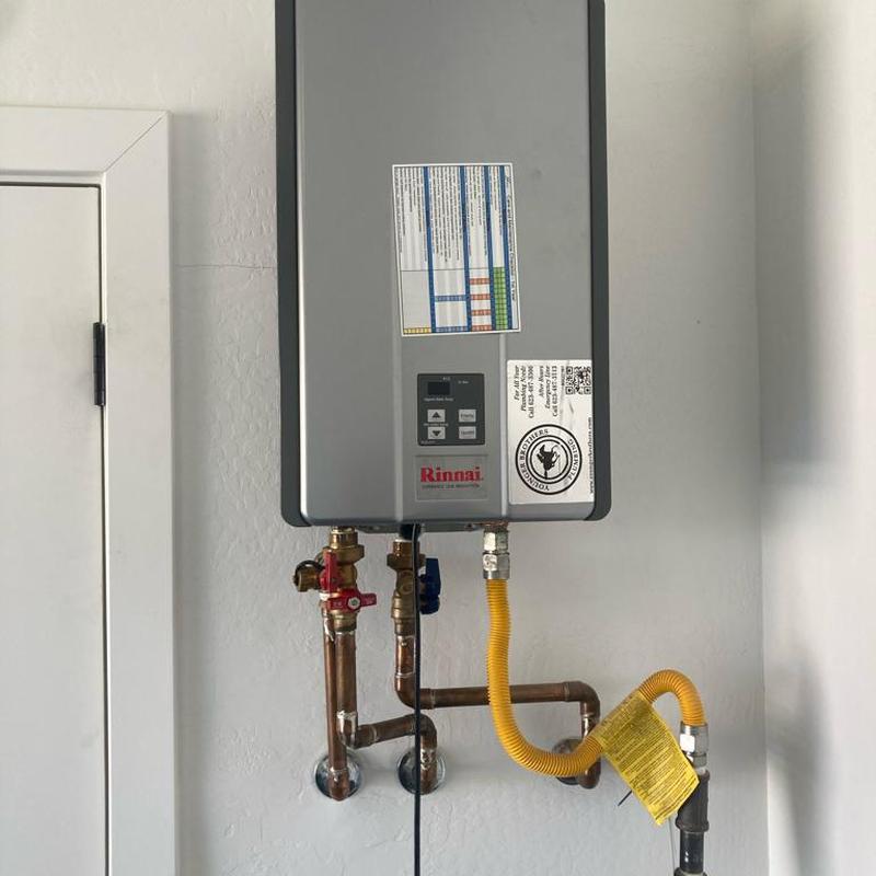 Tankless hot water heater with plumbing connections