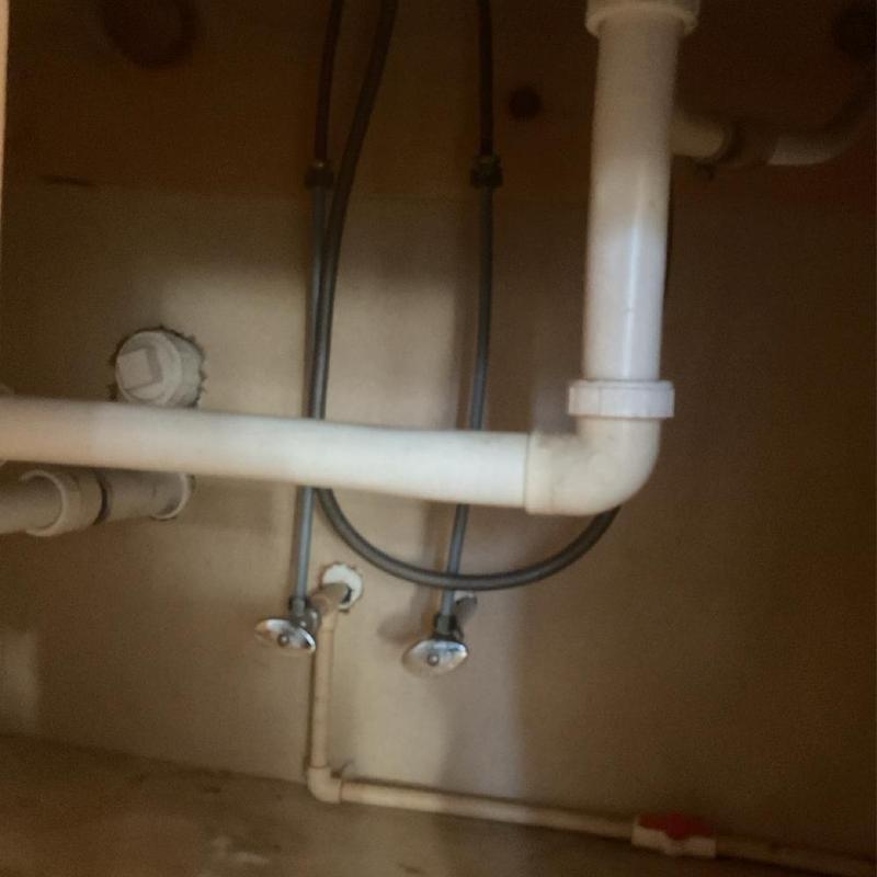 Basket strainer and tubular drain under kitchen sink