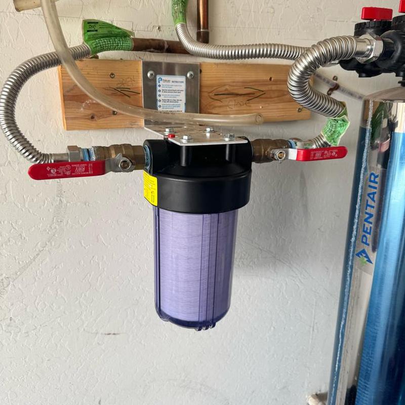 Whole house water filtration unit with new filter replacement