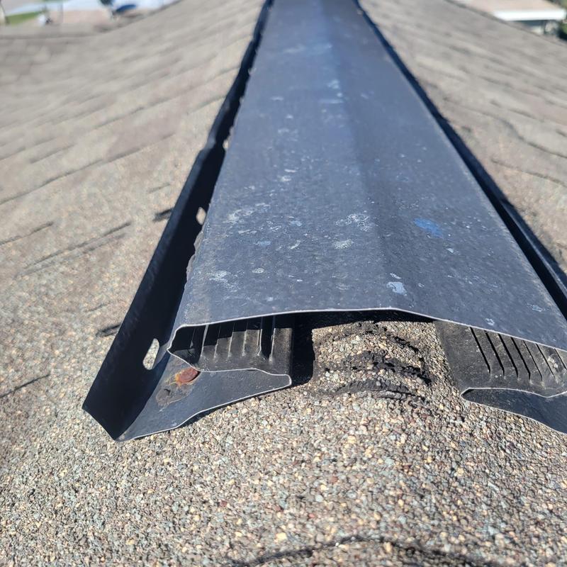 Hip cap shingles with damaged ridge vent section