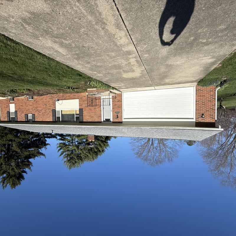 Window with boarded-up glass in brick home facade Window with boarded-up glass in brick home facade