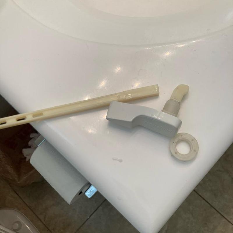 Toilet handle and lever replacement parts on sink edge Toilet handle and lever replacement parts on sink edge