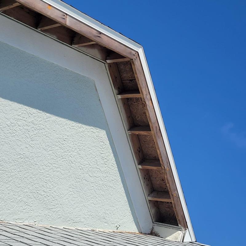 Soffit replacement on Cape Coral roof edge under clear sky