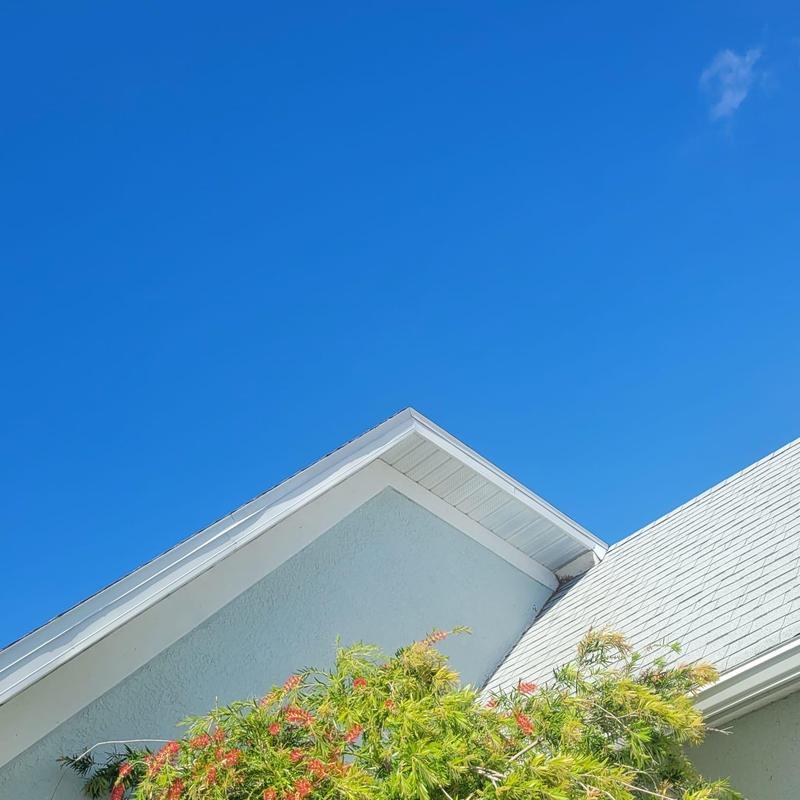 Shingle roof and front soffit replacement under blue sky