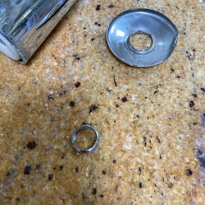 Shower arm broken piece on countertop next to faucet