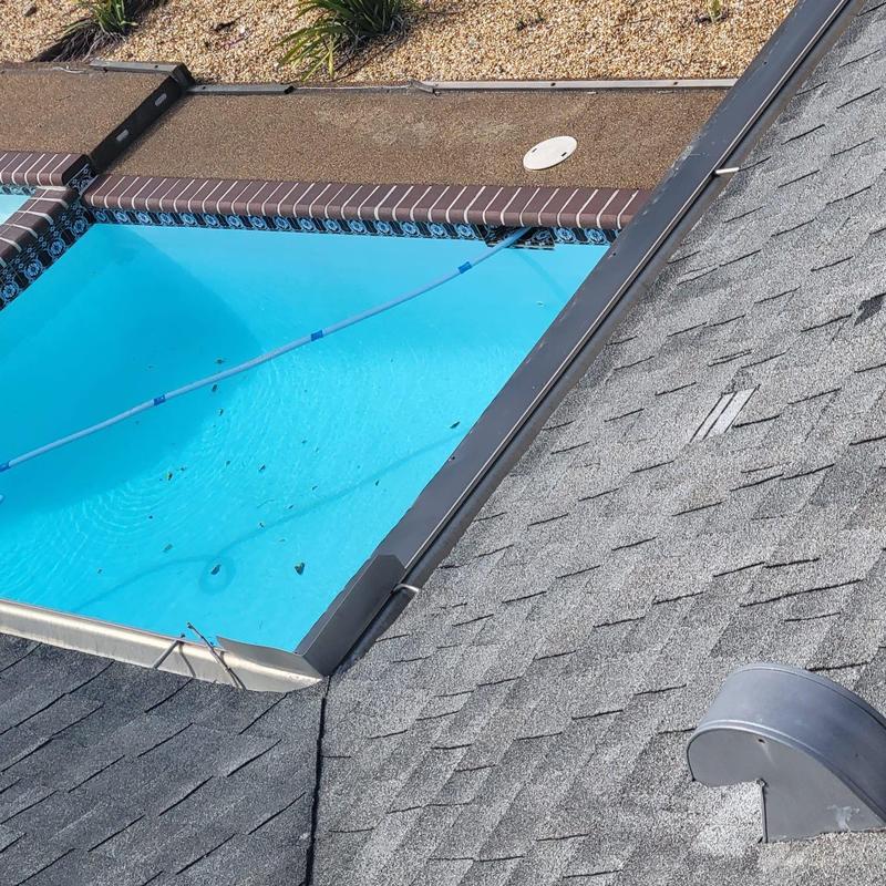 Dryer vent and shingle roof near pool edge