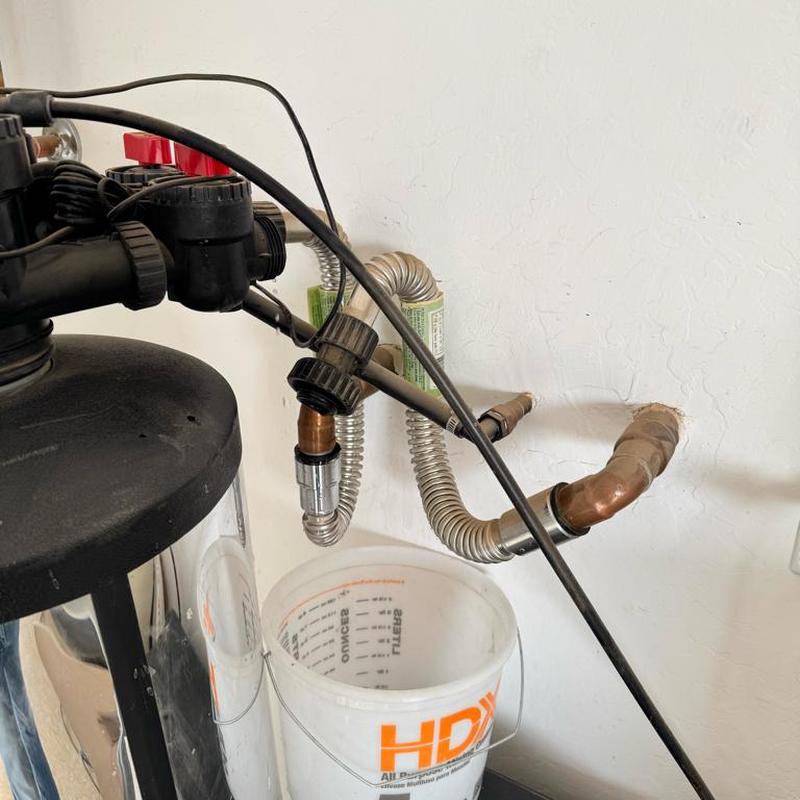 Water softener hose bib with copper adapters in garage