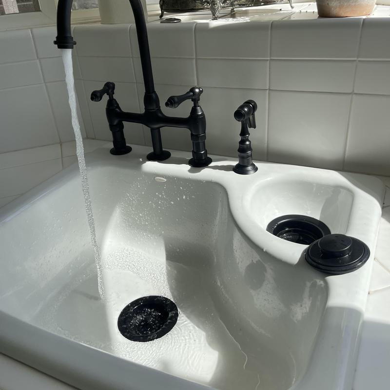 Matte black bridge faucet and basket strainers installation