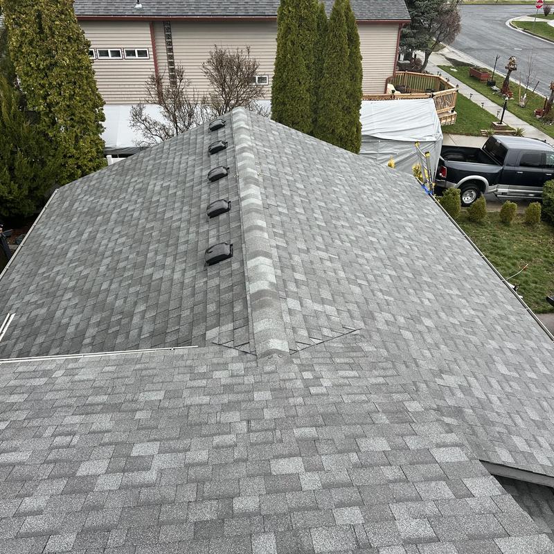 Asphalt shingle roof with ridge vents in residential area