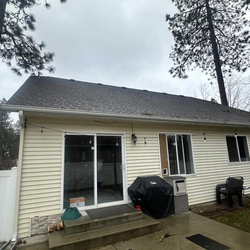 Asphalt shingle roof with sliding glass door and patio