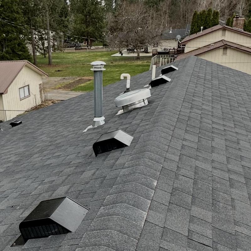 Asphalt shingle roof with vents and pipes