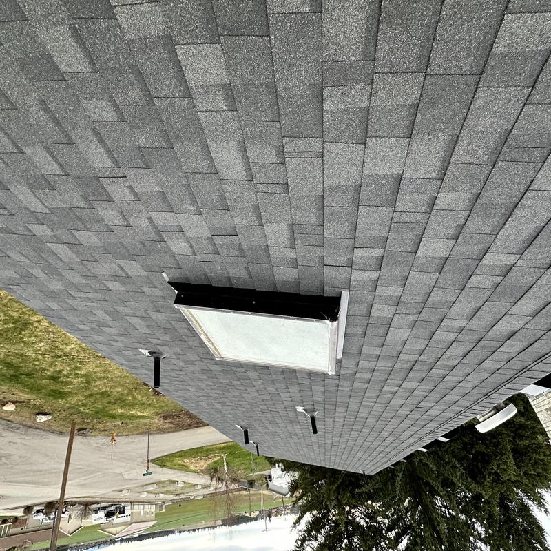 Asphalt shingle roof with skylight and vents installation