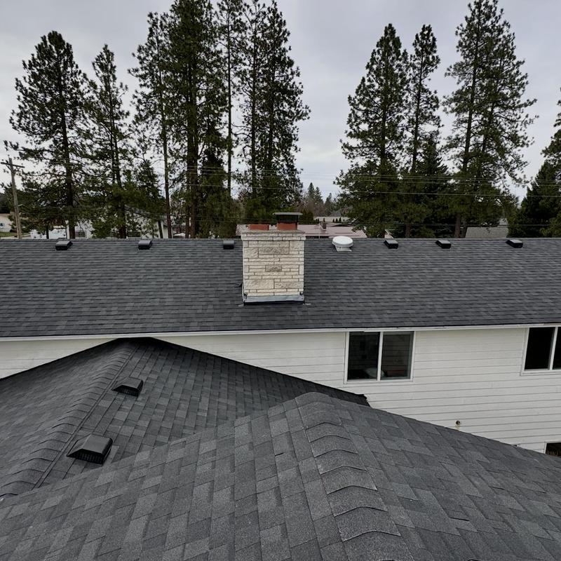 Asphalt shingle roof with chimney and ventilation caps
